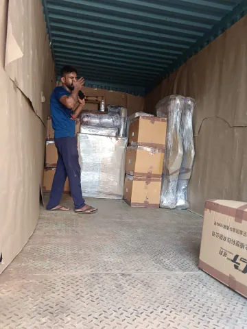 Wrapped items and cartons positioned inside a covered cargo vehicle.
