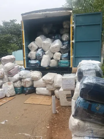 Wrapped household goods with consignment tags inside a moving truck