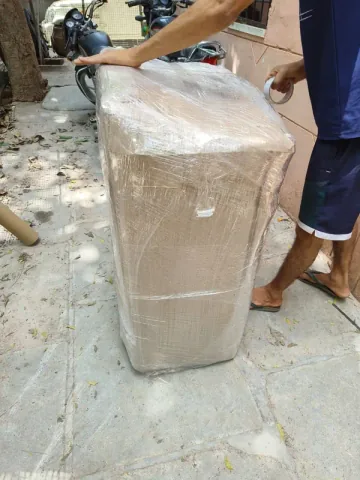 A bulky rectangular item covered with wrapping material and outer film.