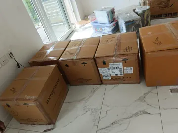 Sealed cartons with handling symbols and labels arranged indoors.