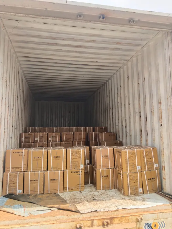 Wooden-framed packages positioned inside a cargo container.