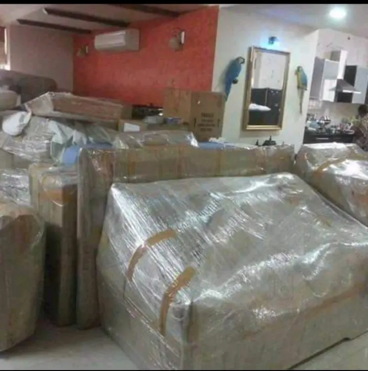 Several wrapped furniture pieces grouped inside a home.