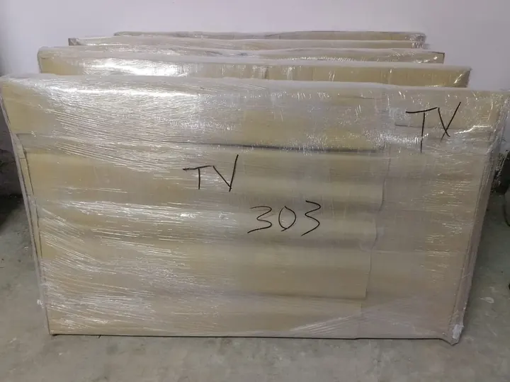 Wrapped flat packages with handwritten TV labels.