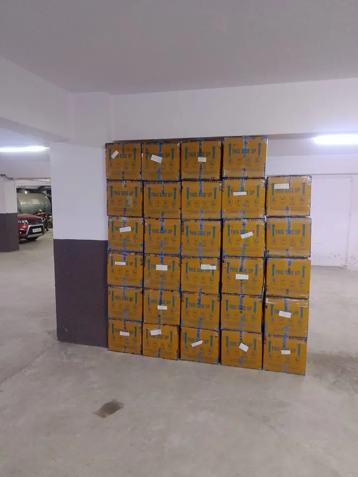 A group of numbered sealed cartons standing at a pickup area.