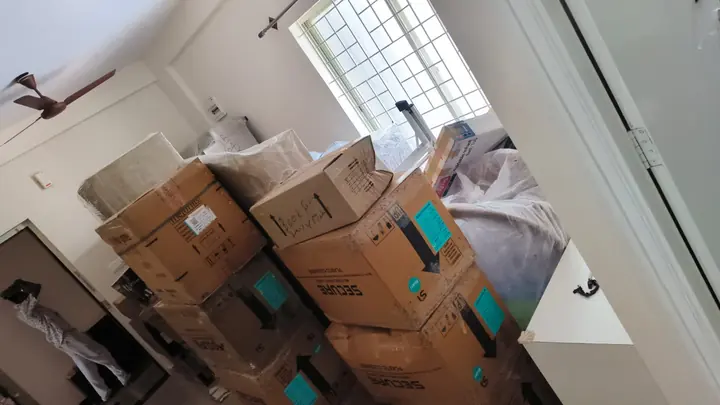 Cartons with visible outer labels grouped inside a home.