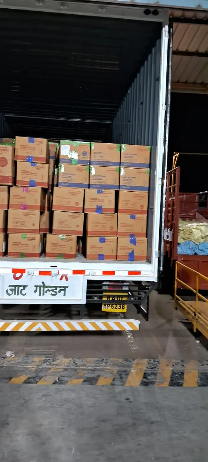 Rows of cartons stacked inside an enclosed cargo vehicle.
