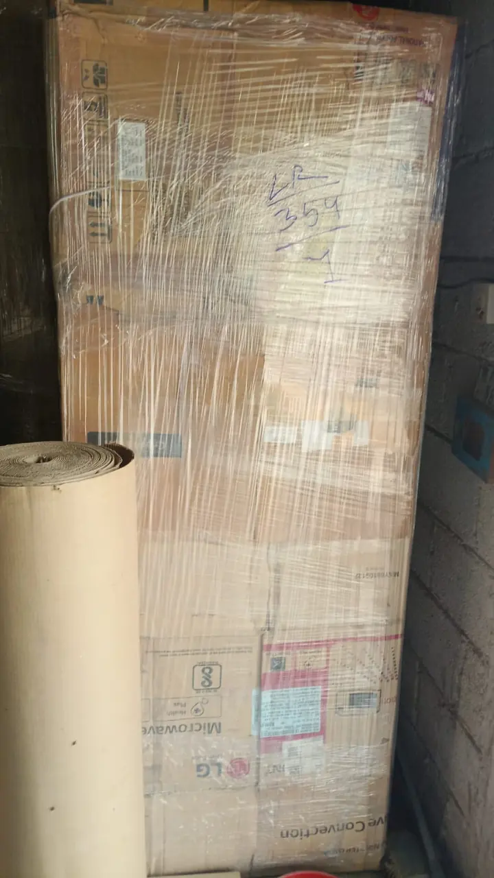 A tall rectangular item covered in protective packing with an outer label attached.